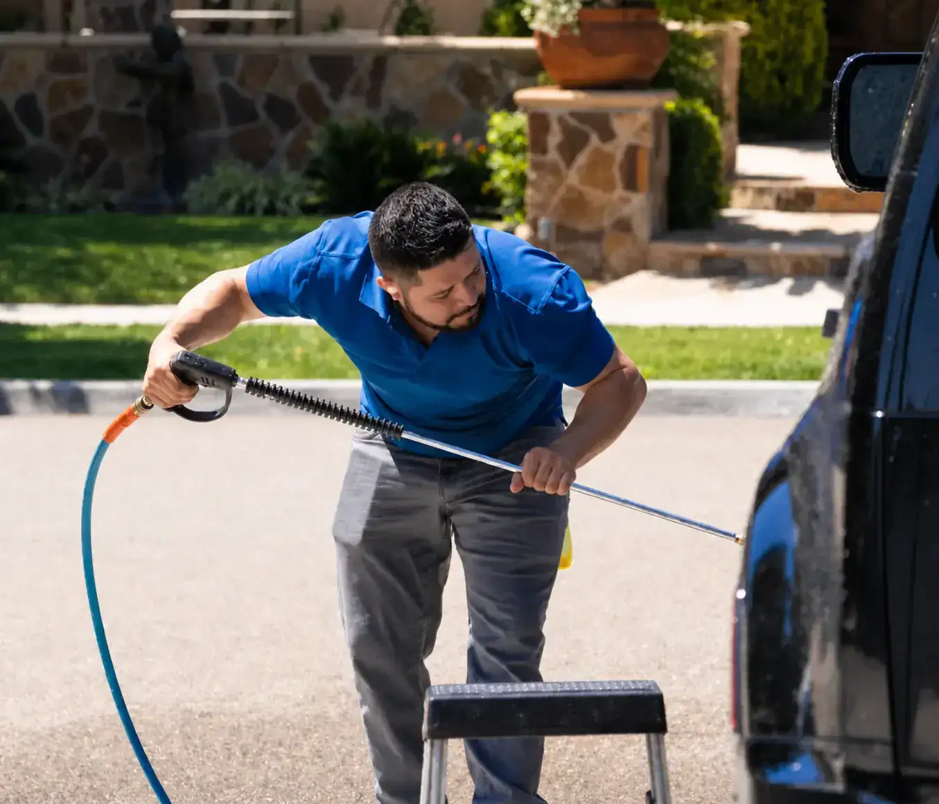 Mobile auto detailer washing a customer vehicle